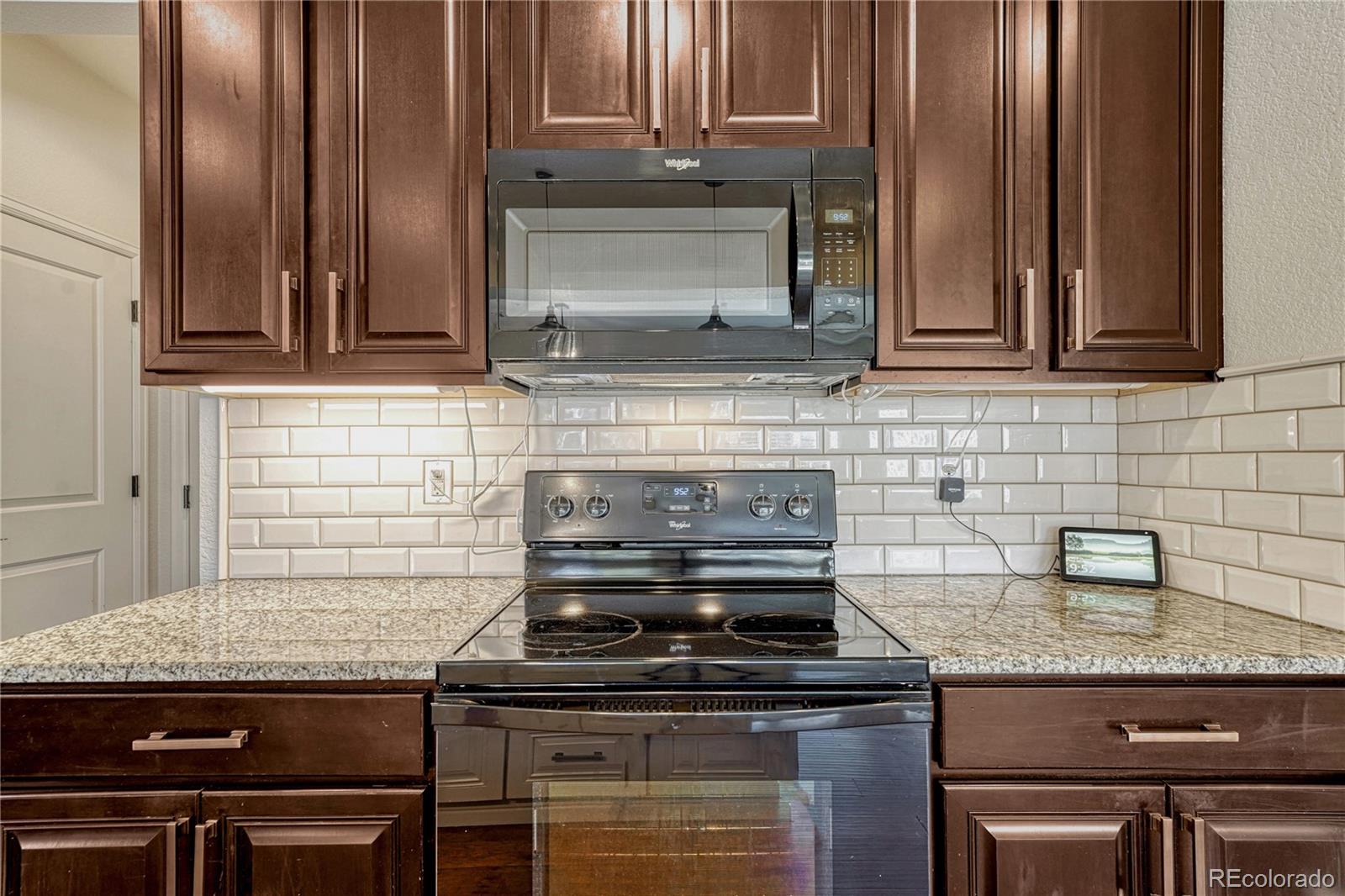 3359 Starry Night Loop Castle Rock, CO 80109 - Photo 12 of 47 a kitchen with granite countertop a stove and a sink