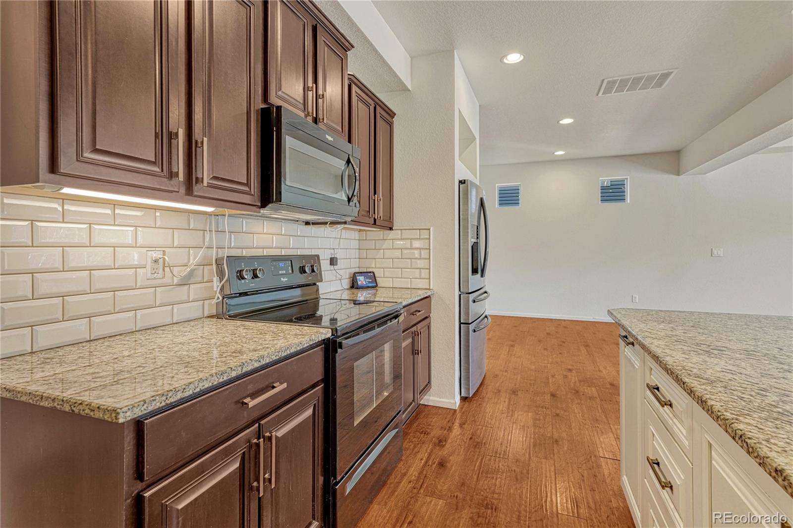 3359 Starry Night Loop Castle Rock, CO 80109 - Photo 13 of 47 a kitchen with stainless steel appliances granite countertop a stove and a sink