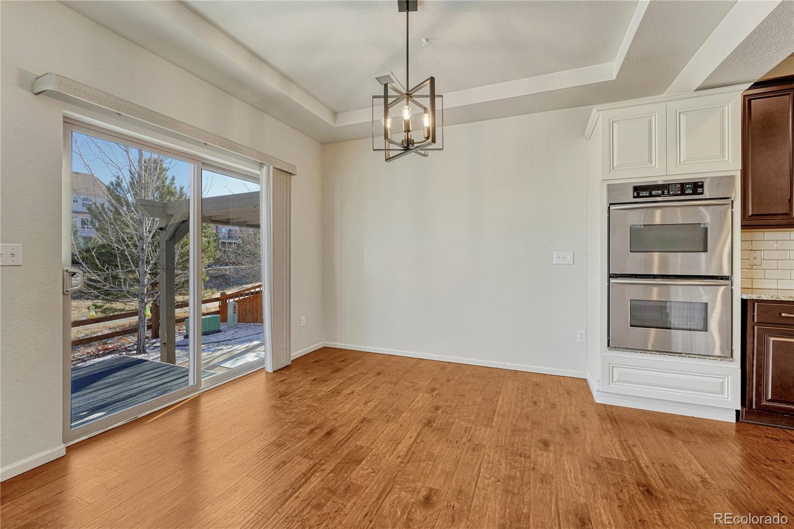 3359 Starry Night Loop Castle Rock, CO 80109 - Photo 14 of 47 a view of a kitchen with wooden floor and windows