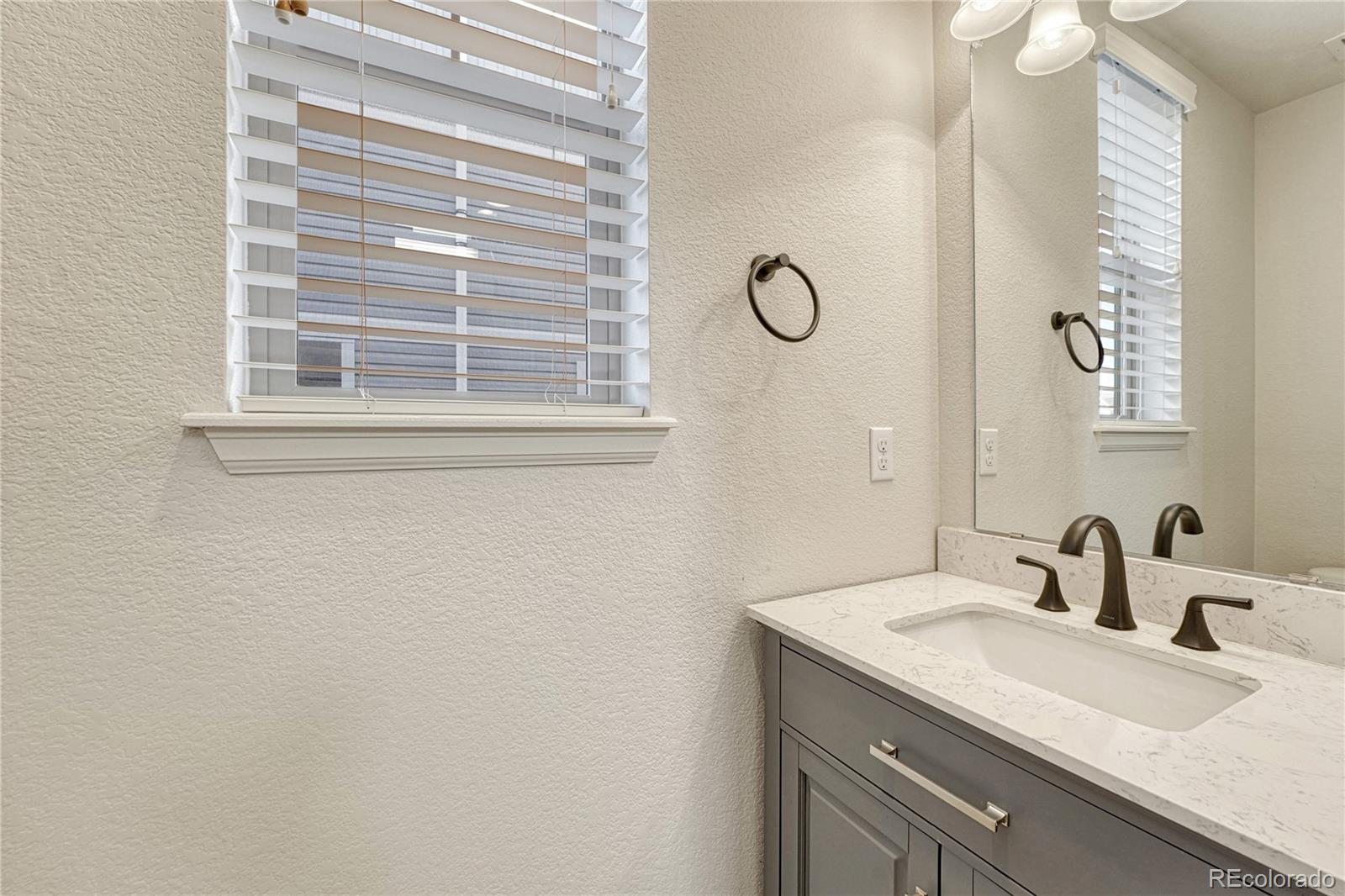 3359 Starry Night Loop Castle Rock, CO 80109 - Photo 19 of 47 a bathroom with a sink and a mirror