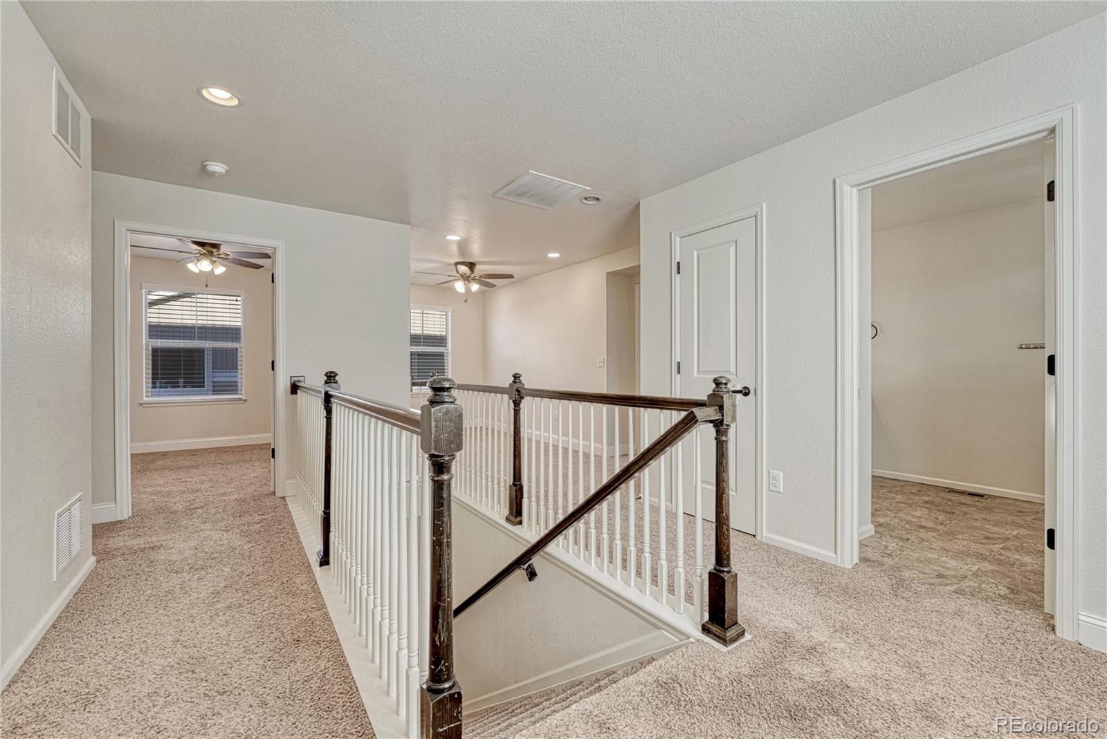 3359 Starry Night Loop Castle Rock, CO 80109 - Photo 20 of 47 a view of a hallway with closet and a chandelier fan