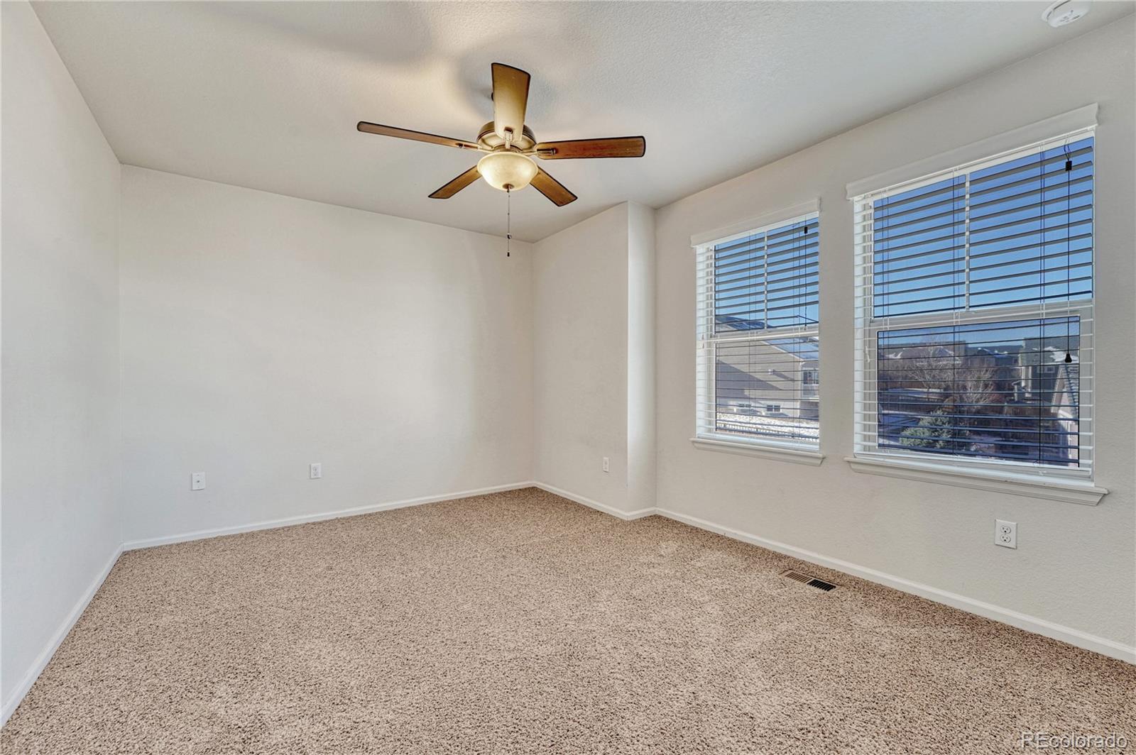 3359 Starry Night Loop Castle Rock, CO 80109 - Photo 32 of 47 an empty room with windows and fan