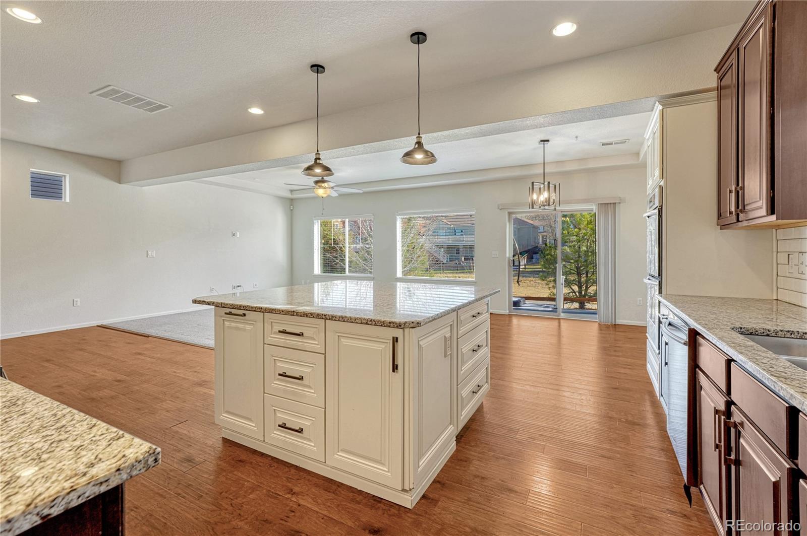 3359 Starry Night Loop Castle Rock, CO 80109 - Photo 9 of 47 a kitchen with stainless steel appliances granite countertop a stove and a sink