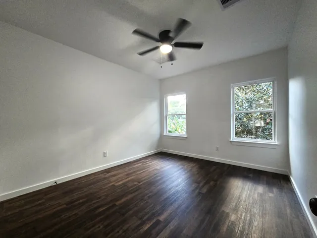 a view of walk in closet with empty racks