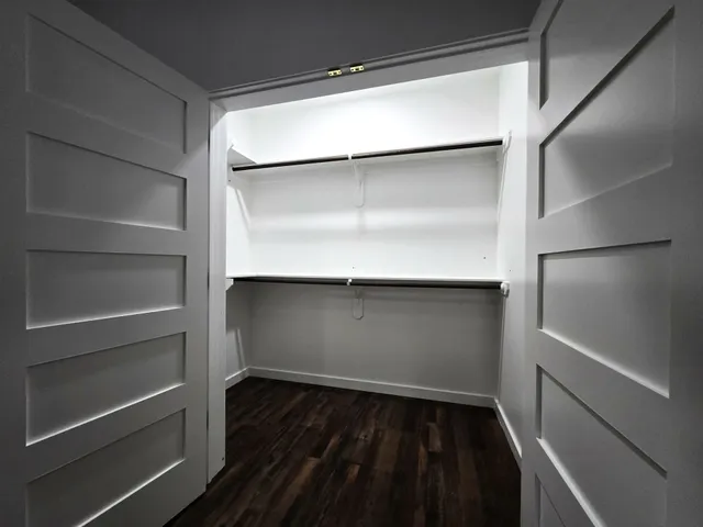 a view of walk in closet with empty racks