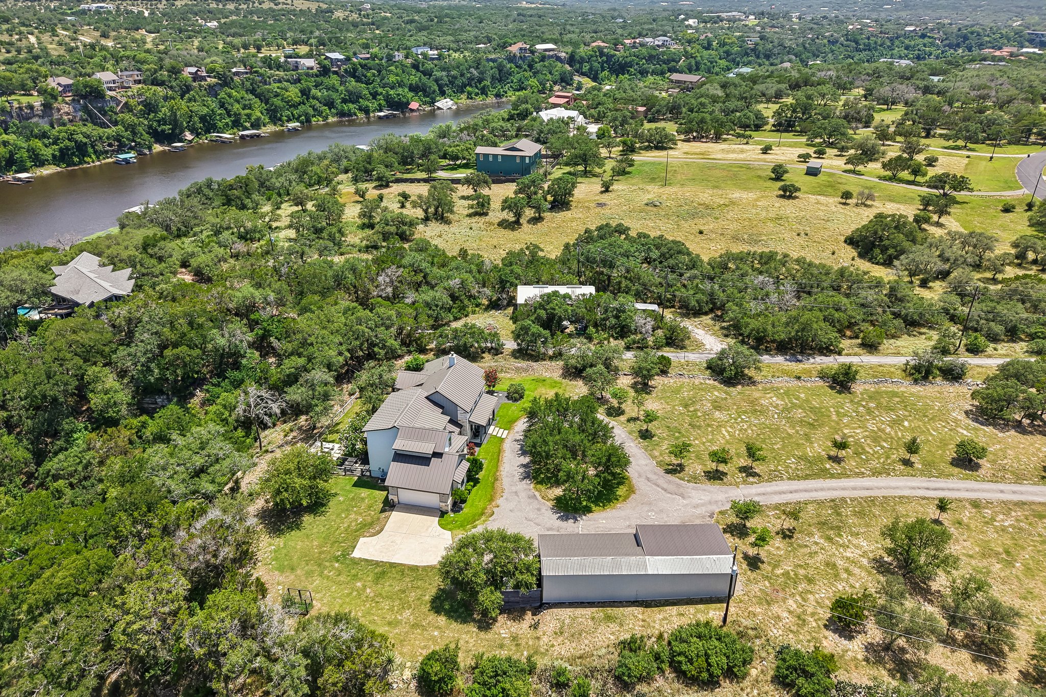 2203 Improver Road Spicewood, TX 78669 - Photo 33 of 38 A tranquil estate featuring a private drive, spacious grounds, and a serene waterfront setting.