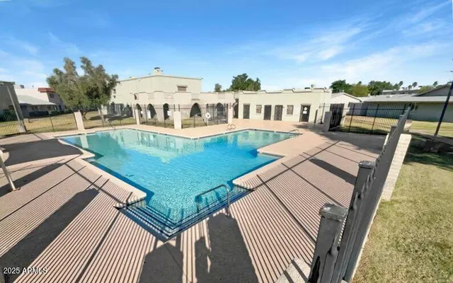 a view of a swimming pool with a patio