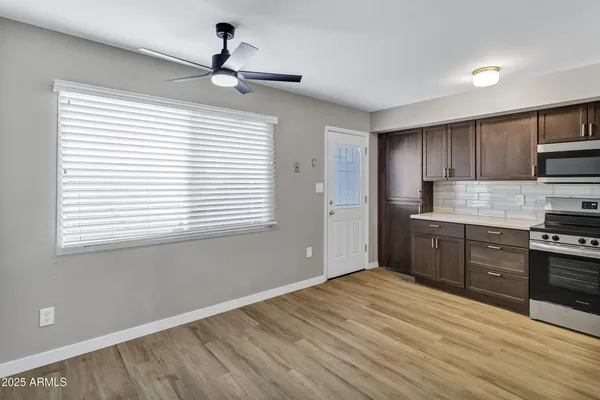 a kitchen with a refrigerator and a stove top oven