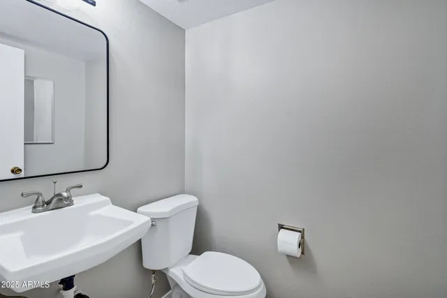 a white toilet sitting next to a bathroom sink