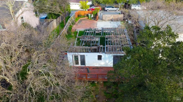 a view of a street with a row of cars parked on the roadside