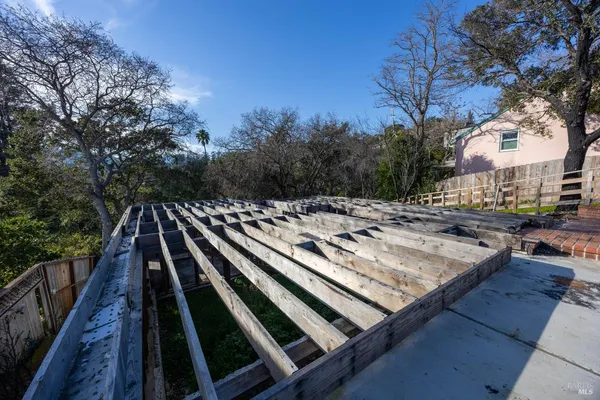 a view of barbeque grill with wooden fence