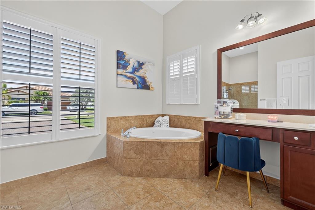 5102 Genoa Street Immokalee, FL 34142 - Photo 15 of 36 a spacious bathroom with a sink mirror and a bathtub