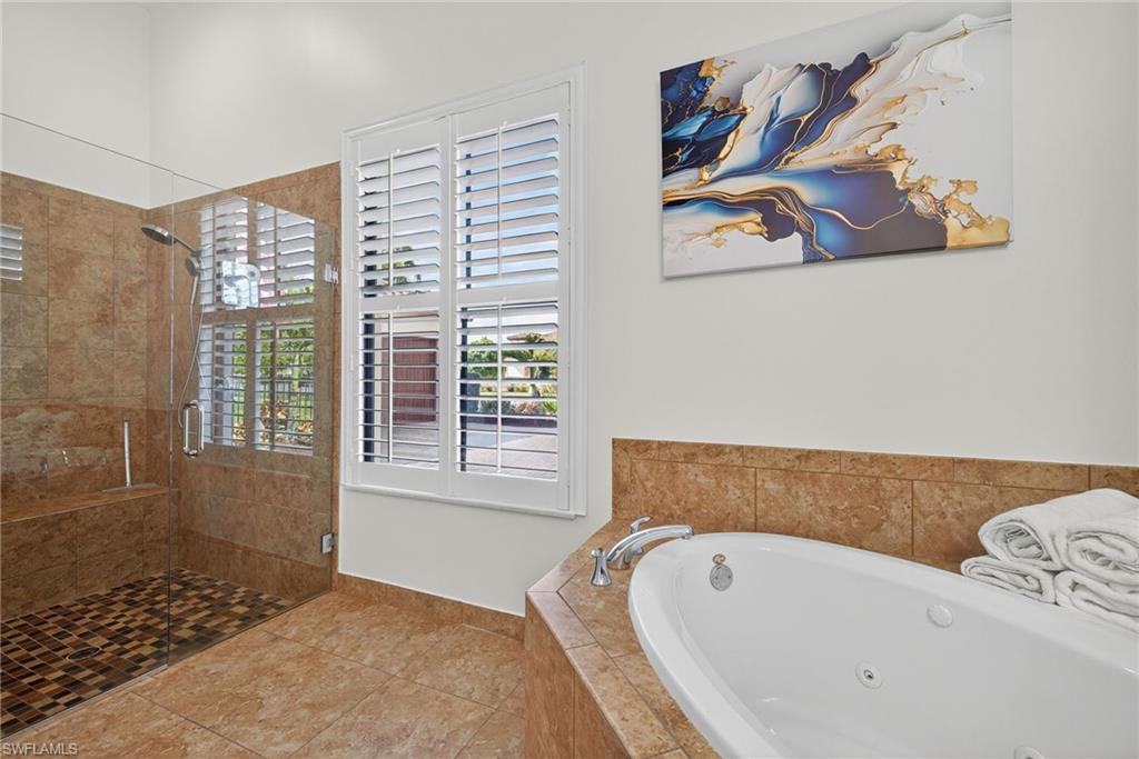 5102 Genoa Street Immokalee, FL 34142 - Photo 16 of 36 a bathroom with a tub and a window