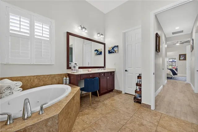 a bathroom with a tub sink and mirror