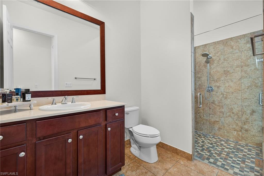 5102 Genoa Street Immokalee, FL 34142 - Photo 19 of 36 a bathroom with a sink a toilet and shower