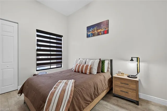 a bed room with a bed and a night stand