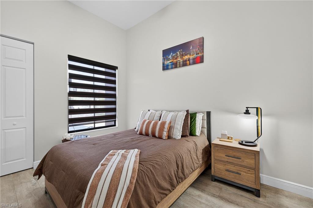 5102 Genoa Street Immokalee, FL 34142 - Photo 20 of 36 a bed room with a bed and a night stand