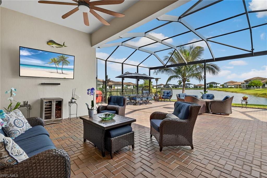 5102 Genoa Street Immokalee, FL 34142 - Photo 25 of 36 a living room with furniture and a floor to ceiling window