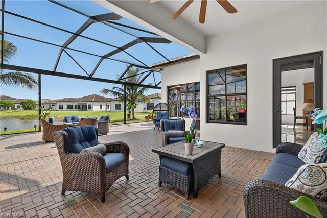 a living room with furniture and a floor to ceiling window