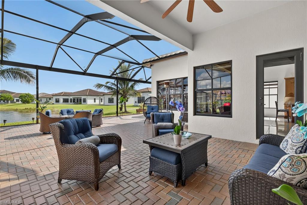 5102 Genoa Street Immokalee, FL 34142 - Photo 26 of 36 a living room with furniture and a floor to ceiling window