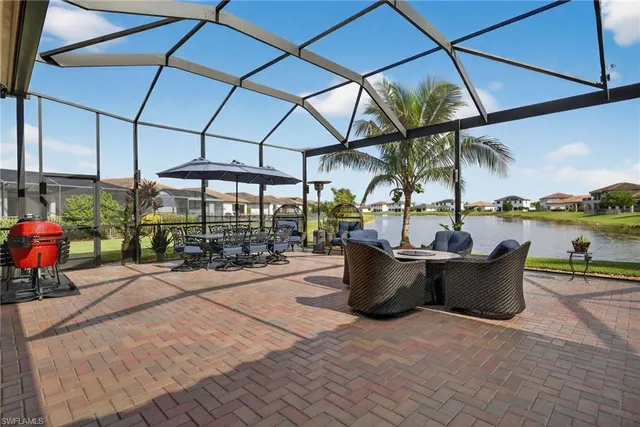 a view of a patio with a dining table and chairs under an umbrella