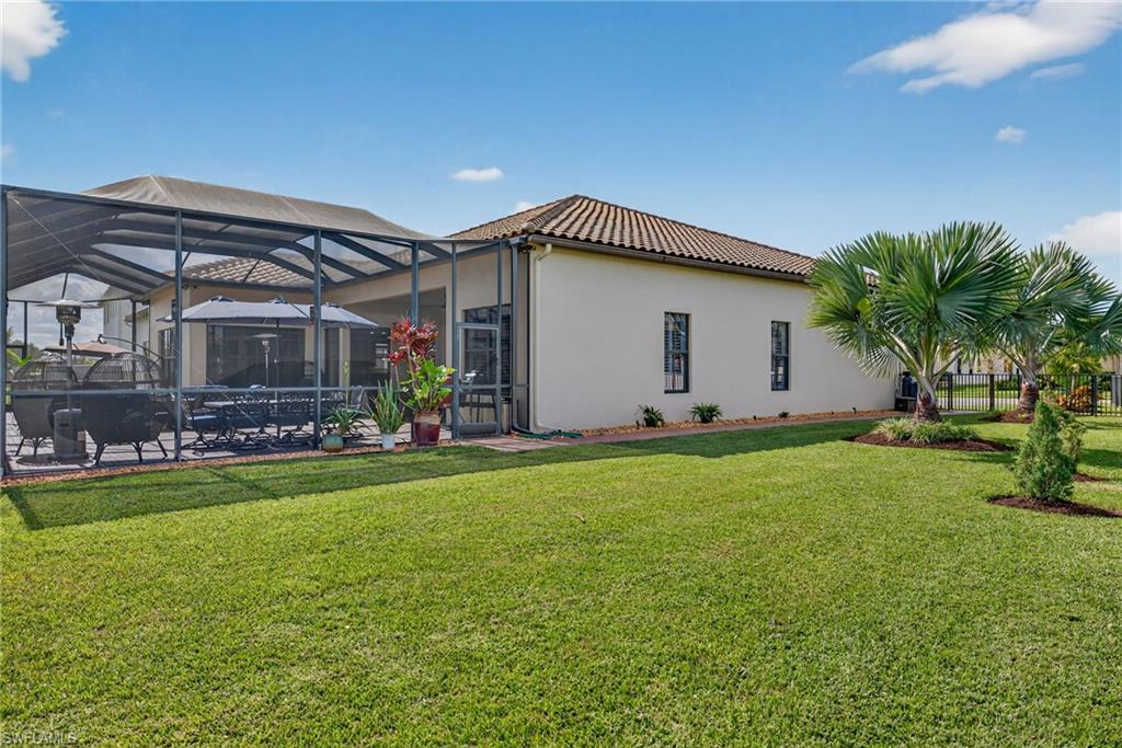 5102 Genoa Street Immokalee, FL 34142 - Photo 30 of 36 a front view of house with yard and outdoor seating