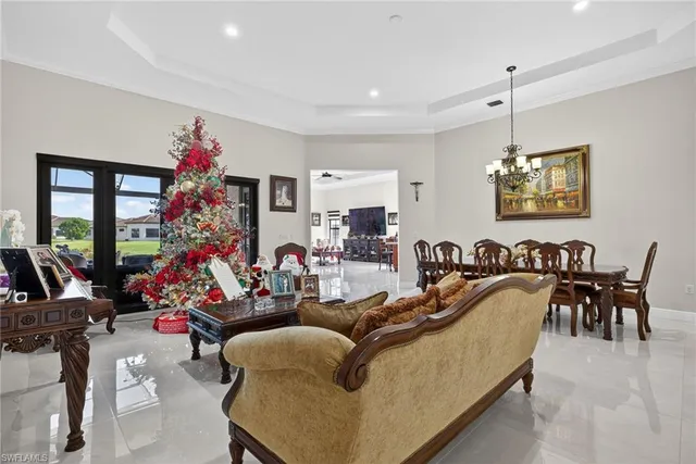 a living room with furniture flowers and a chandelier