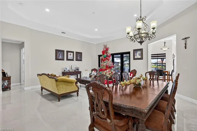 a view of a dining room with furniture and a chandelier