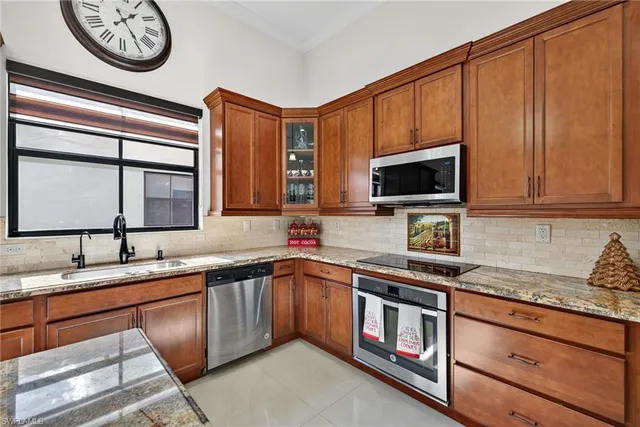 a kitchen with stainless steel appliances granite countertop a sink stove and microwave