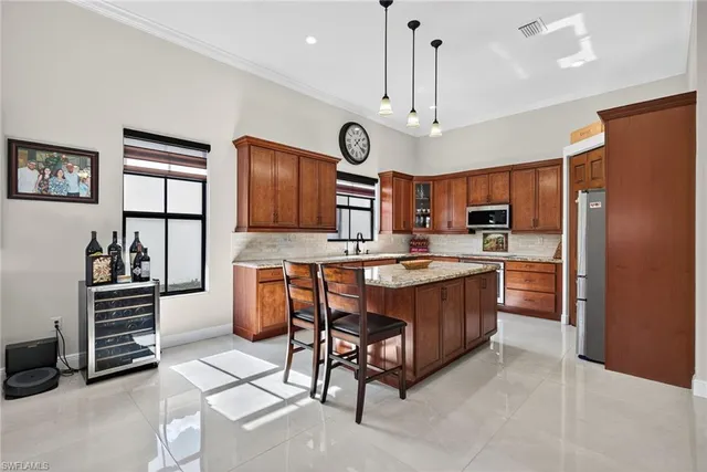 a large kitchen with a large window and stainless steel appliances