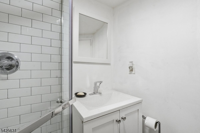 60 Westervelt Place Lodi, NJ 07644 - Photo 33 of 48 a bathroom with a sink toilet and shower