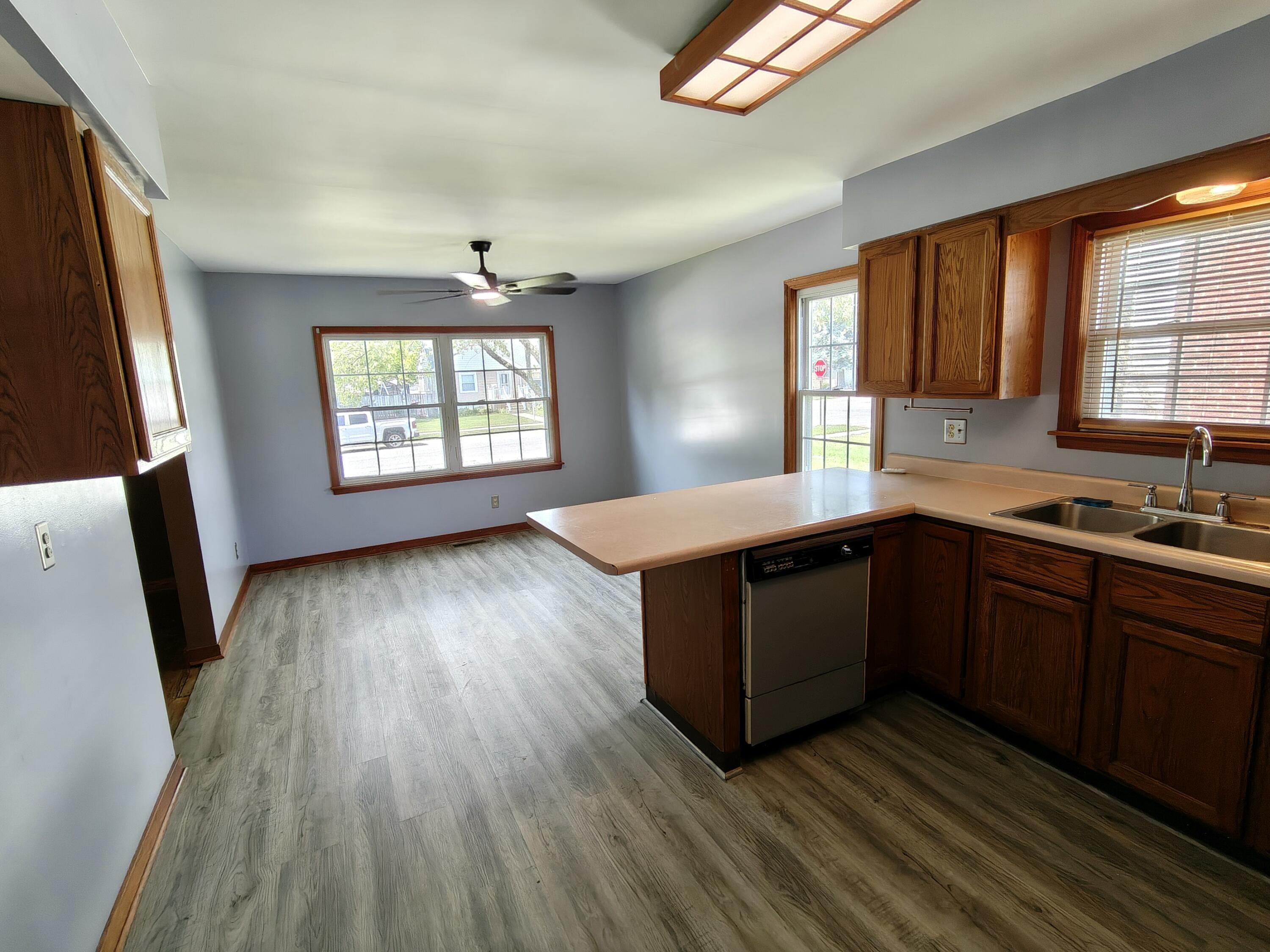 245 North Indiana Street Griffith, IN 46319 - Photo 8 of 30 a kitchen with wooden floors and a sink