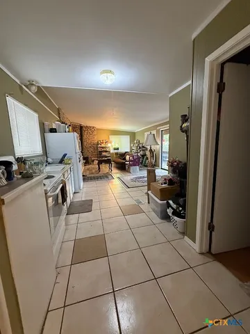 a kitchen with a white cabinets and white appliances