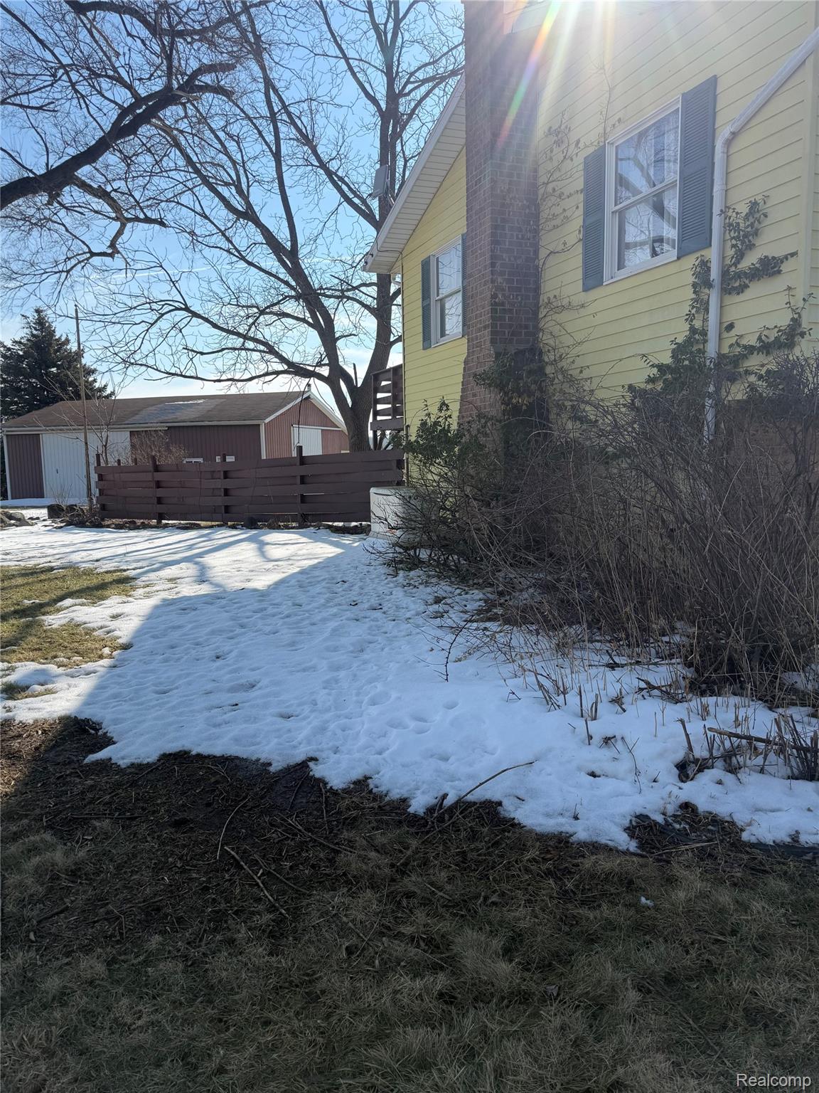 5749 Leix Road Mayville, MI 48744 - Photo 12 of 44 View of snowy exterior featuring an outbuilding and a chimney