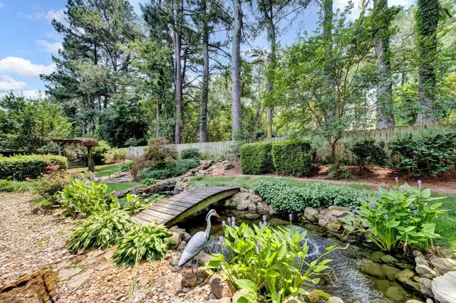 a view of backyard with plants and outdoor seating
