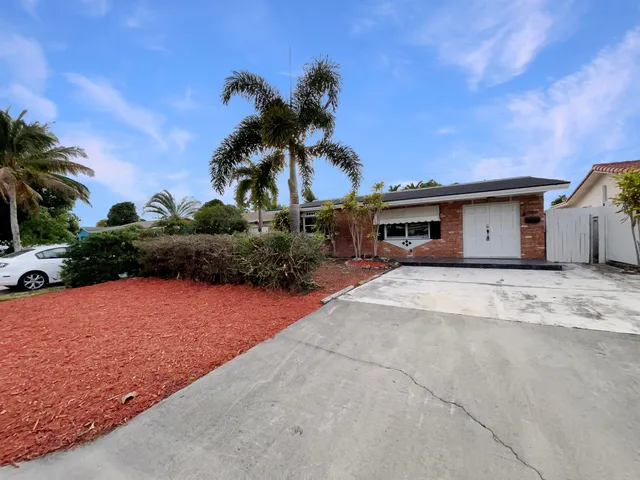 a house with palm tree in the background