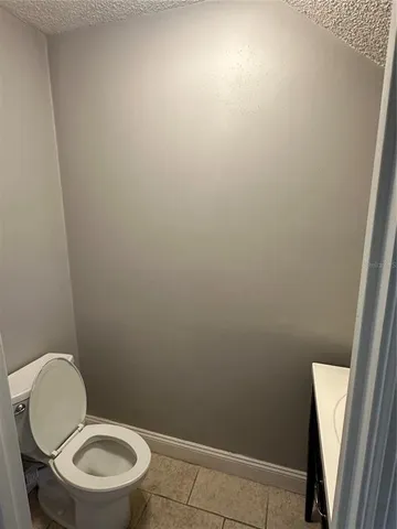 a white toilet sitting next to a shower