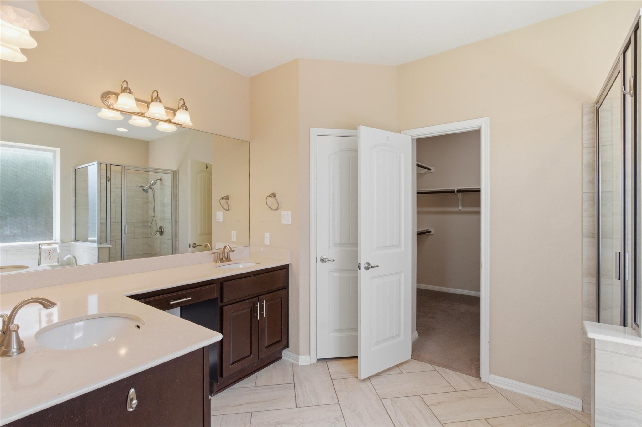 1511 Rimstone Drive Cedar Park, TX 78613 - Photo 20 of 39 A spacious primary bathroom boasts a dual vanity, separate shower, and walk-in closet.