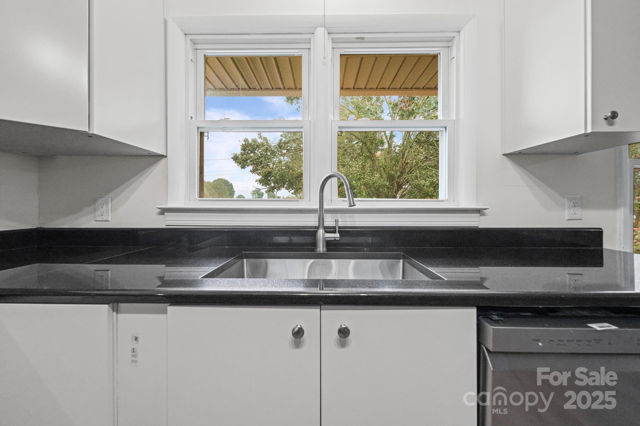 1331 Stegall Road Marshville, NC 28103 - Photo 11 of 35 a kitchen with granite countertop a sink and a window