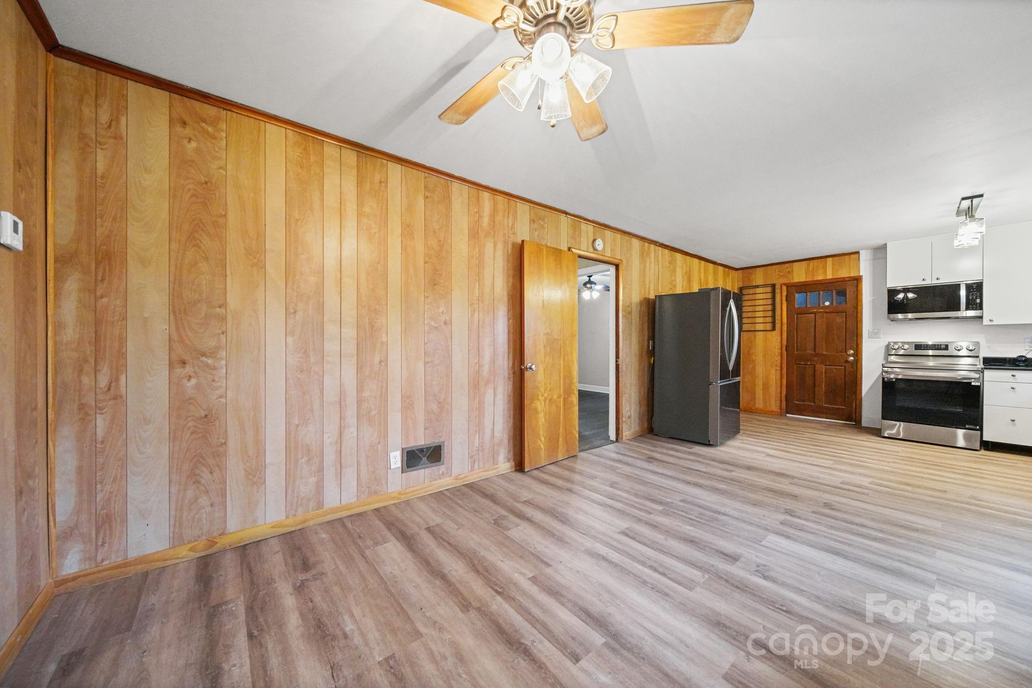 1331 Stegall Road Marshville, NC 28103 - Photo 14 of 35 a view of a livingroom with a flat screen tv kitchen view and a window