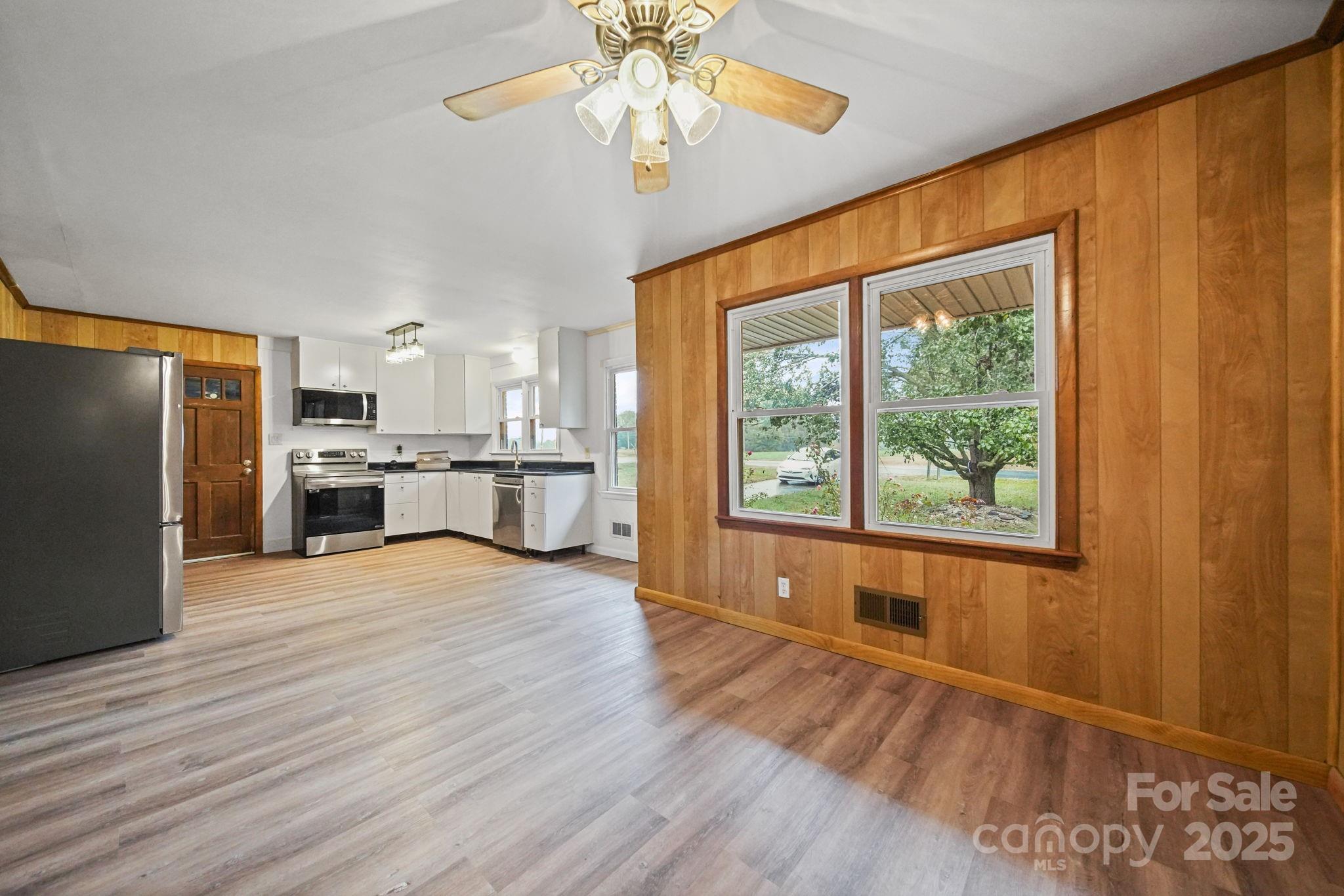 1331 Stegall Road Marshville, NC 28103 - Photo 15 of 35 a view of a kitchen with wooden floor and a kitchen