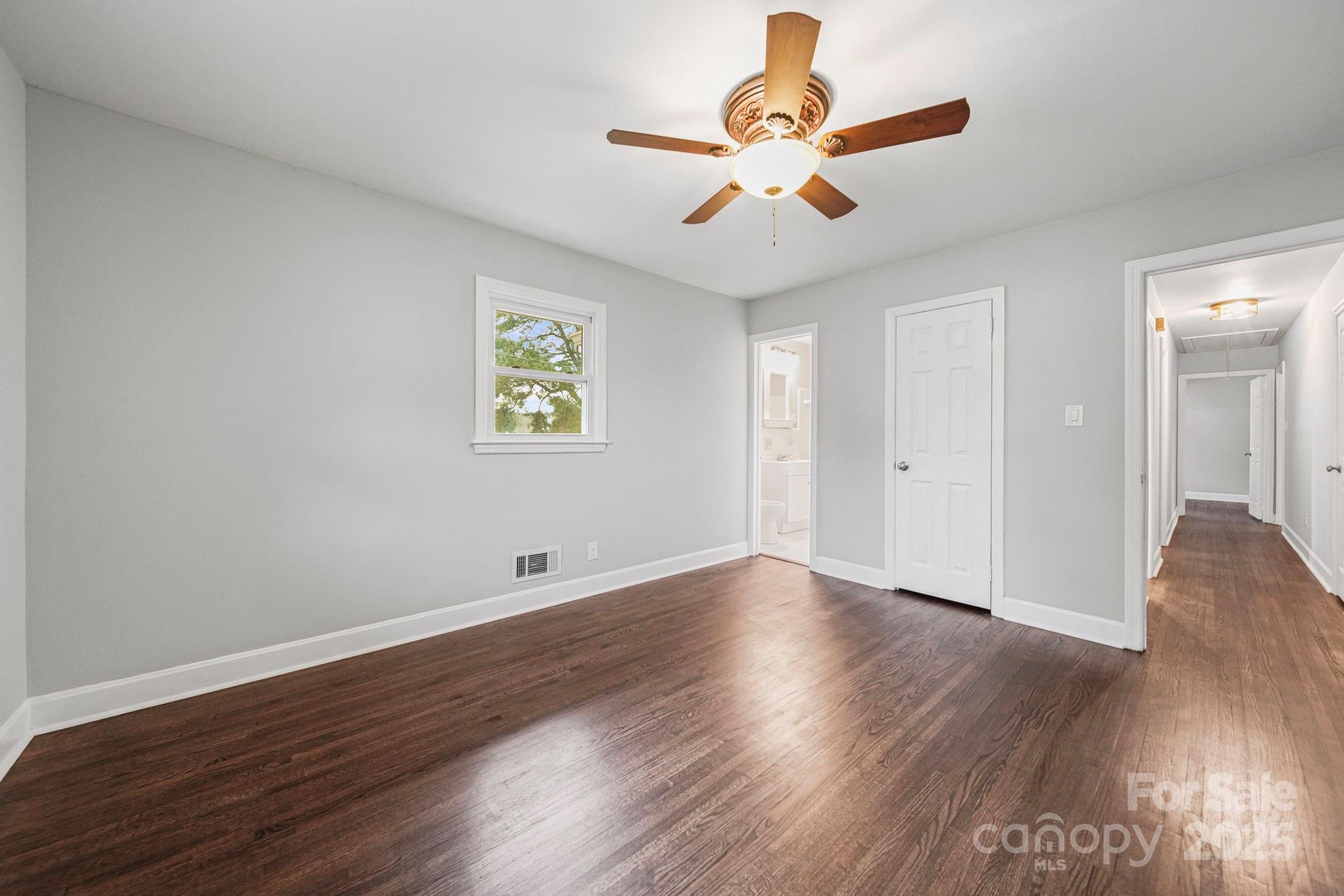 1331 Stegall Road Marshville, NC 28103 - Photo 17 of 35 a view of an empty room with wooden floor and a ceiling fan