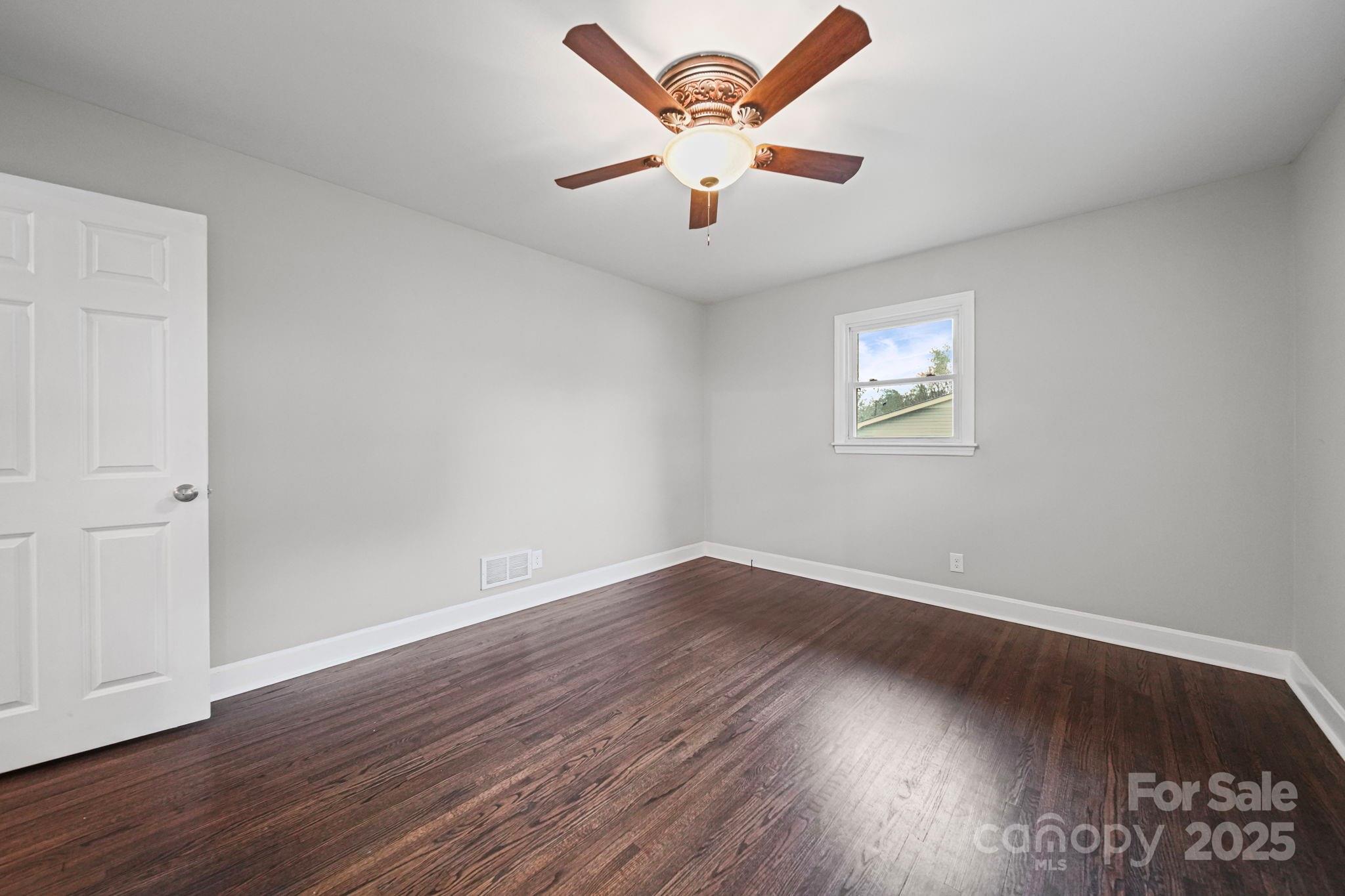 1331 Stegall Road Marshville, NC 28103 - Photo 18 of 35 an empty room with wooden floor and ceiling fan