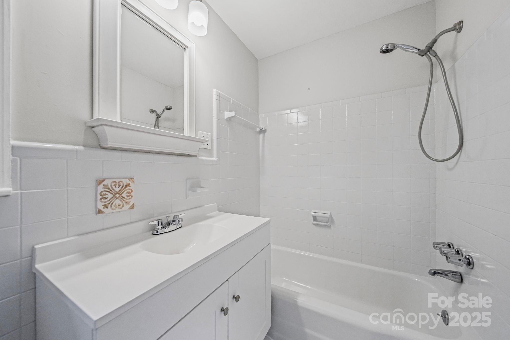 1331 Stegall Road Marshville, NC 28103 - Photo 19 of 35 a bathroom with a sink a vanity and shower