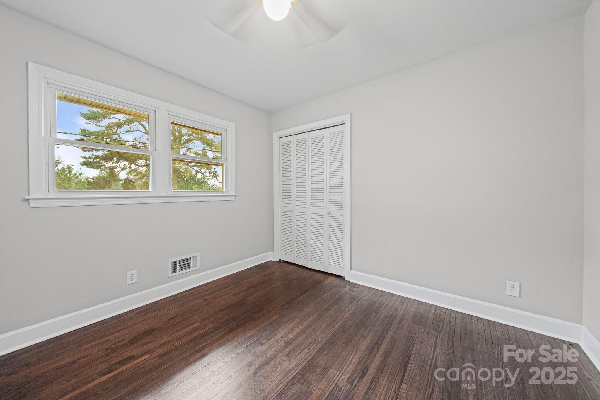 1331 Stegall Road Marshville, NC 28103 - Photo 21 of 35 an empty room with wooden floor and windows