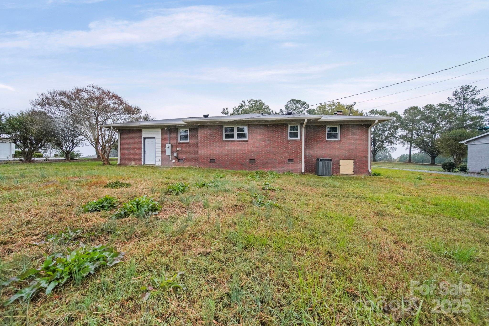 1331 Stegall Road Marshville, NC 28103 - Photo 32 of 35 a view of a house with a big yard and large trees