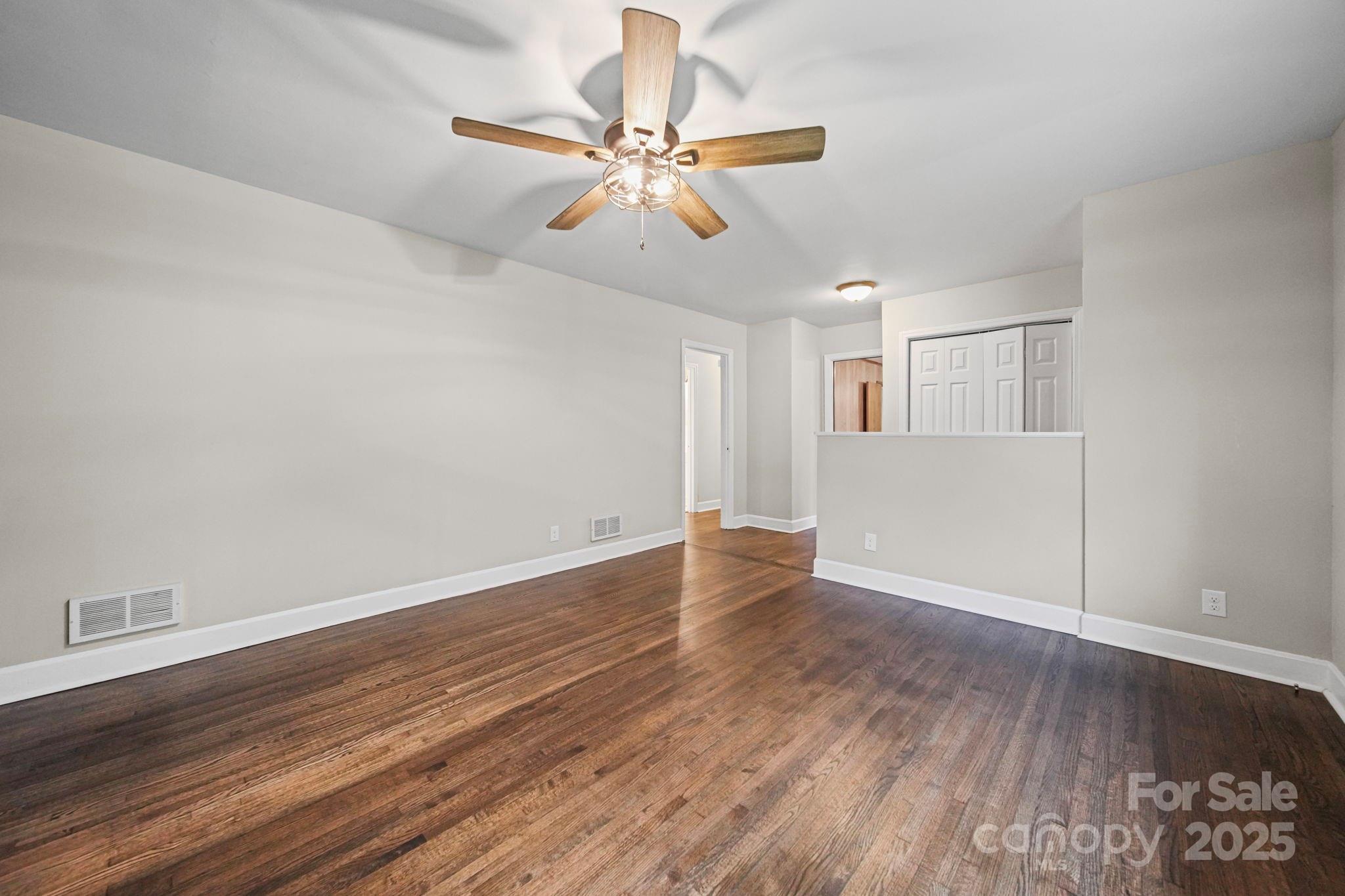1331 Stegall Road Marshville, NC 28103 - Photo 4 of 35 an empty room with wooden floor fan and windows