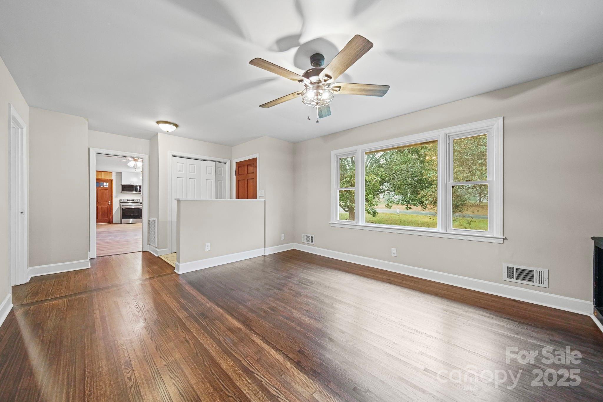 1331 Stegall Road Marshville, NC 28103 - Photo 5 of 35 a view of an empty room with wooden floor and a window