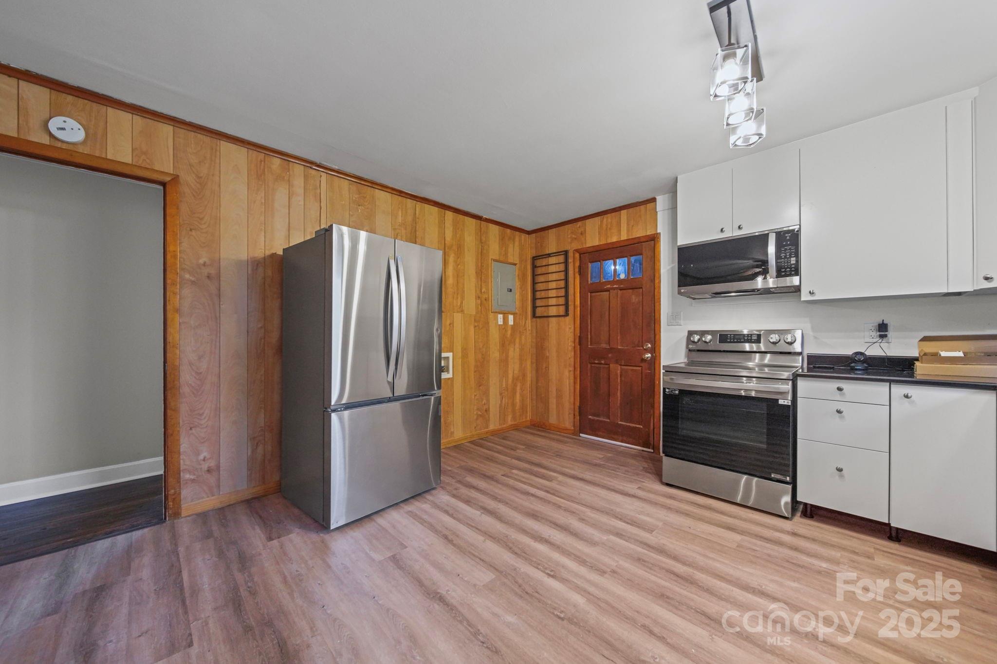 1331 Stegall Road Marshville, NC 28103 - Photo 8 of 35 a kitchen with a refrigerator stove and wooden floor