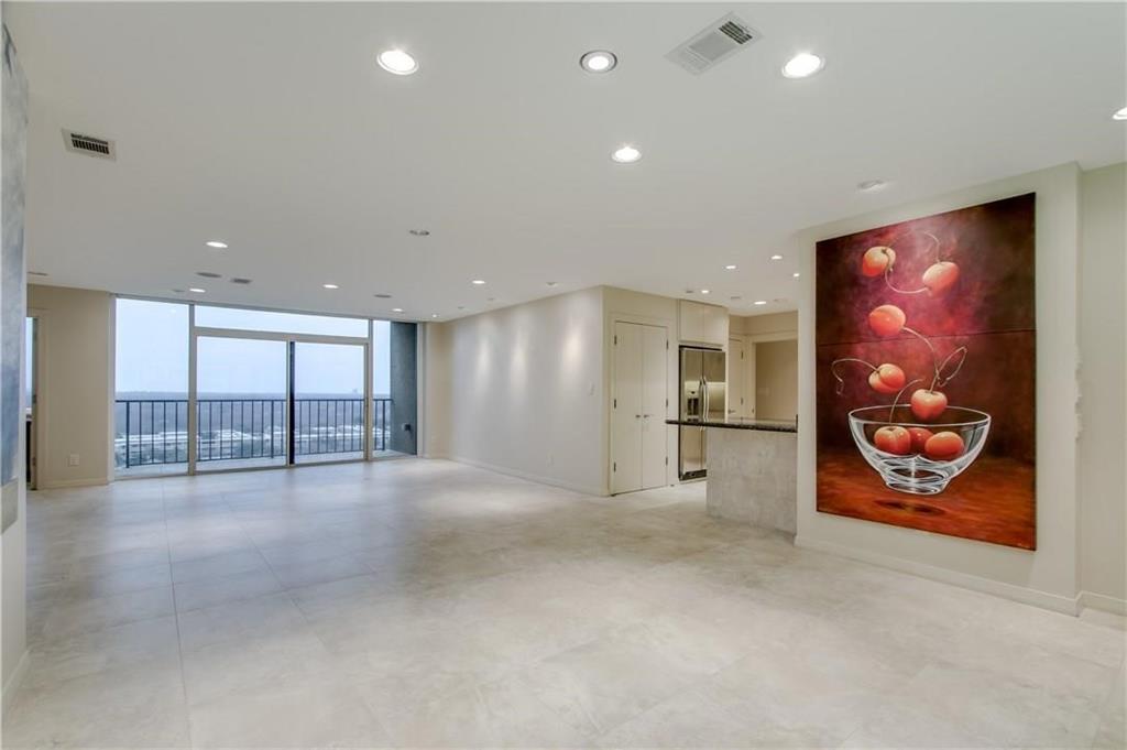 a view of an empty room with painting on the wall